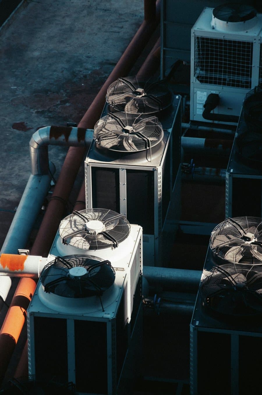 Cooling units and pipework on the technical roof of a data center.